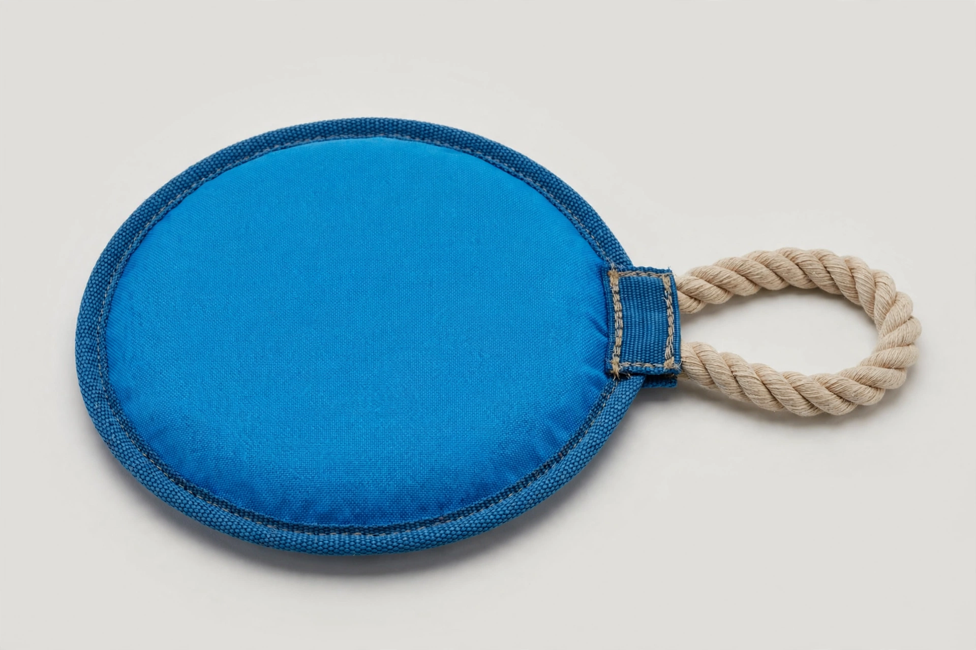 Illustrative sample: blue nylon dog rope disc flying toy with rope handle.