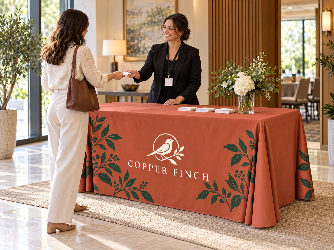 A welcoming hotel event check-in with a branded table cover